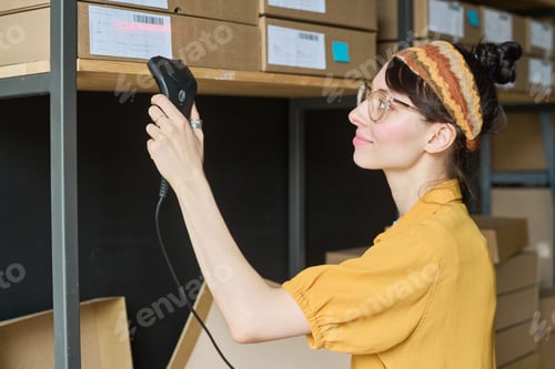 Preview: Woman scanning parcels on shelf