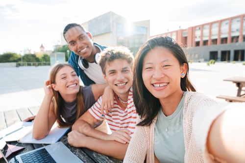 Preview: A group of happy and diverse teenagers smiling, taking a selfie portrait together during a student
