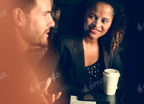 Preview: Partners discussing business over coffee
