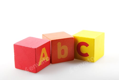 Preview: Closeup of wooden alphabet blocks isolated on a white background
