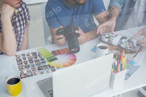 Preview: Team of photographers working together at desk