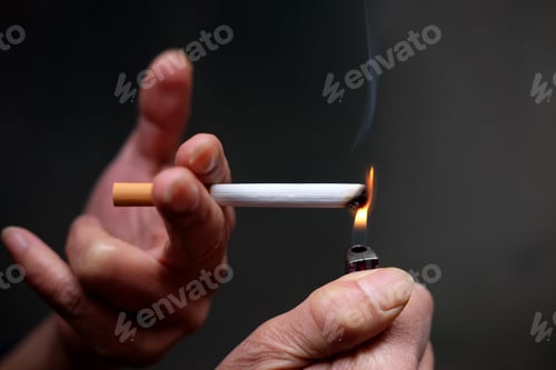 Preview: Closeup shot of a person lighting a cigarette in front of a black background