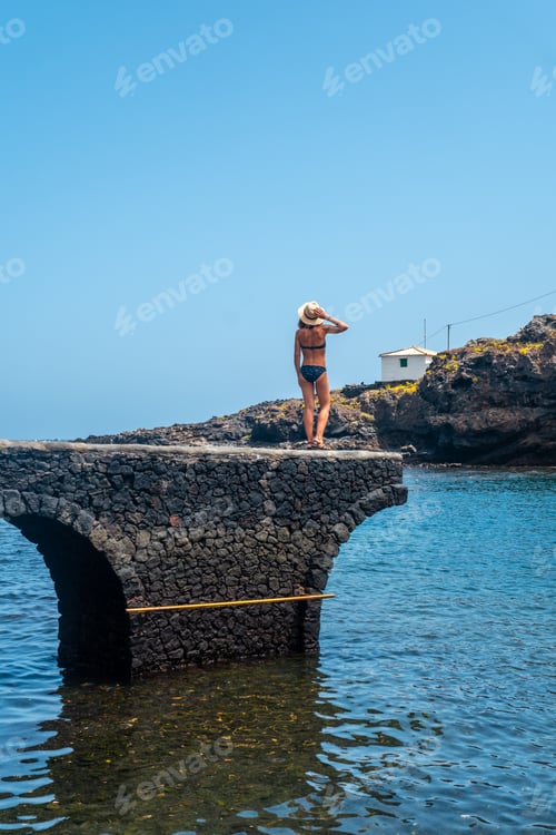Preview: A young woman on vacation in the seaside tourist village Tamaduste on the island of El Hierro