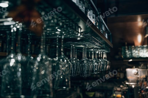 Preview: Dimly lit bar with hanging wine glasses.