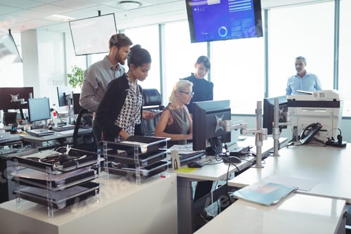 Preview: Focused business team working together in office