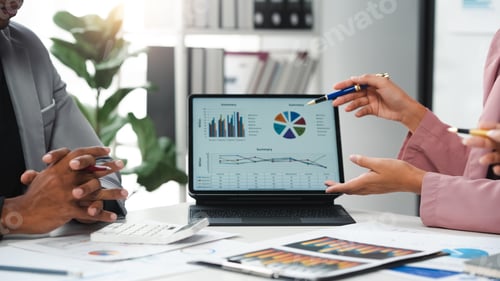 Preview: Business team analyzing financial data using digital tablet during meeting