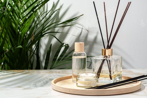 Preview: Black Reed Diffuser, Amber Candle, and Wooden Tray on White Surface