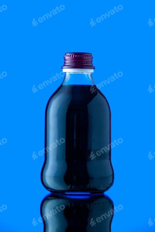 Preview: front view glass bottle with black juice on blue background