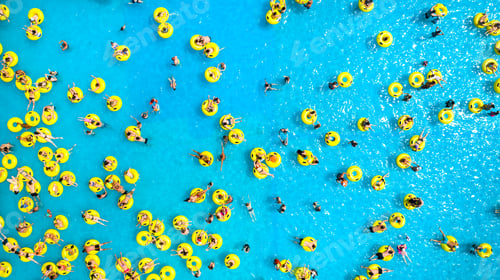 Preview: Top view of People relaxing in the pool on yellow inflatable circles