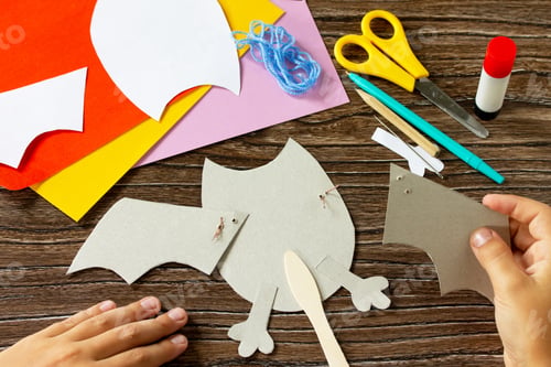Preview: The child glues the details of dracola bat toy Halloween.