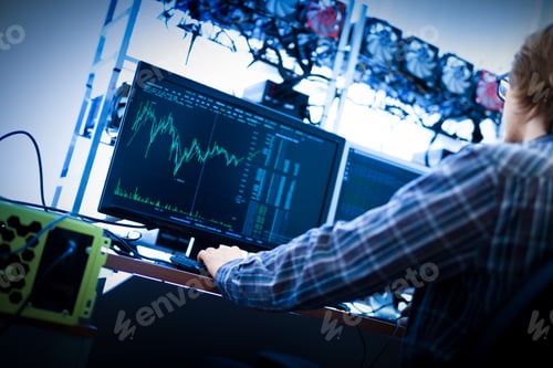 Preview: Man working on the computer with bitcoin analyst software.