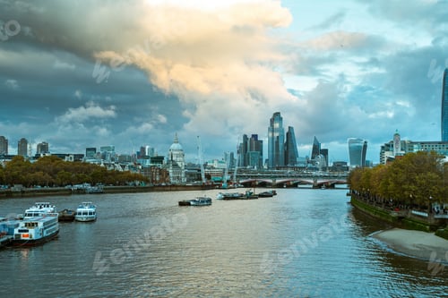 Preview: Wide angle shot of the skyscrapers of a city in front of the water under a sky full of clouds