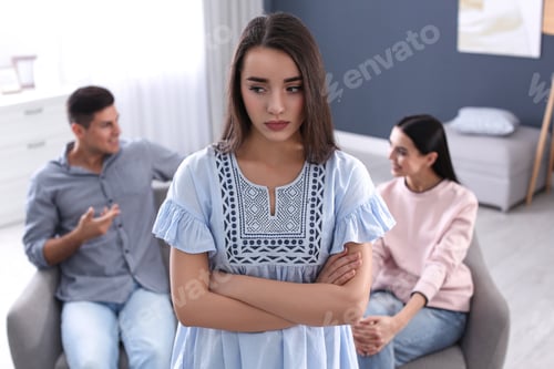 Preview: Unhappy woman feeling jealous while couple spending time together at home