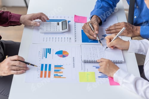 Preview: Group of confident business people point to graphs and charts to analyze market data, balance sheet,