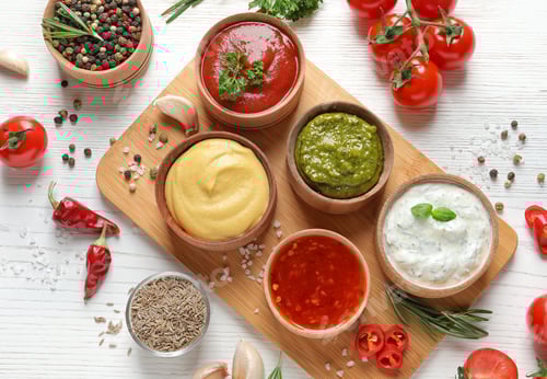 Preview: Flat lay composition with different sauces and ingredients on white wooden background