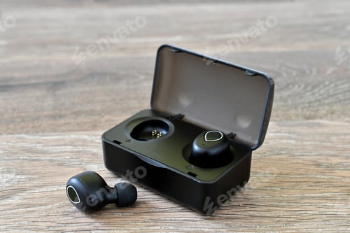 Preview: Generic Black wireless earbuds in a charging case on a wood background. (logos and labels removed)
