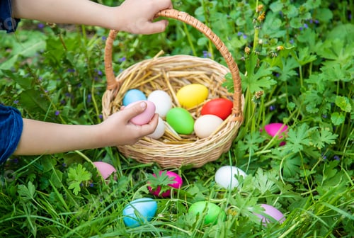 Preview: Krashenki homemade eggs in the basket and the hands of a child. Selective focus.
