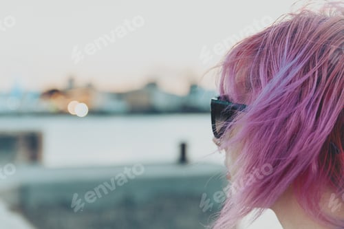 Preview: Closeup shot of a pretty pink-haired young female with a piercing and sunglasses
