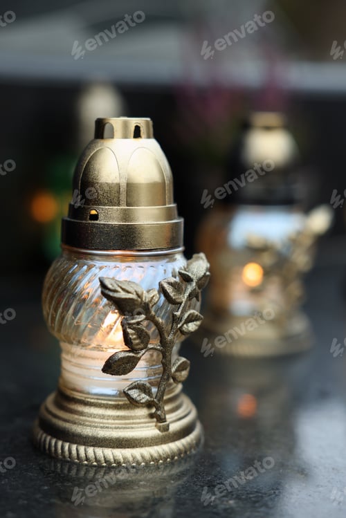 Preview: Grave lights on granite surface at cemetery