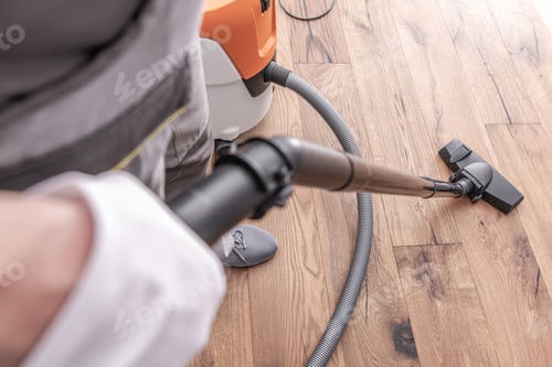 Vacuum Cleaner Cleans a Wood Floor