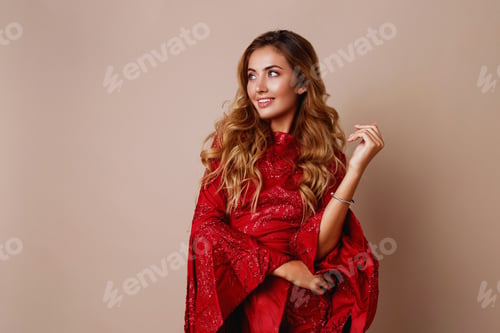 Preview: Studio fashion portrait of young blond celebrating woman