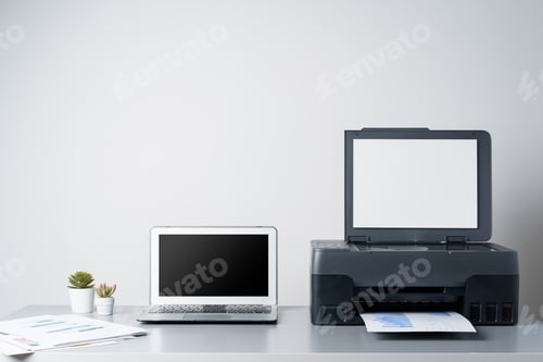 Preview: Printer and laptop on grey table in office