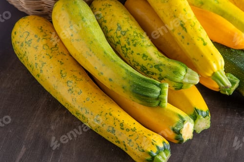 Preview: Yellow-green leopard-spotted zucchini. Vegetables on the table. Zucchini harvest.