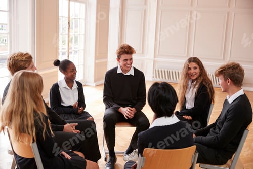 Preview: Group Of Teenage Students Having Discussion In Class Together