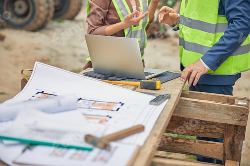 Preview: Woman in workwear and her colleague standing outdoors