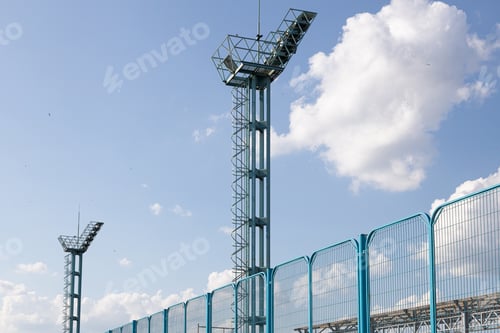 Preview: Two old metal a bit rusty watch towers against light sky