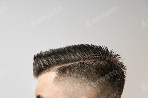 Preview: Perfect styling of hair after barbershop on the grey background. Hair loss treatment concept. Mens