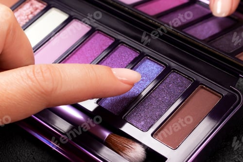 Preview: Female finger touching colorful eye shadow palette