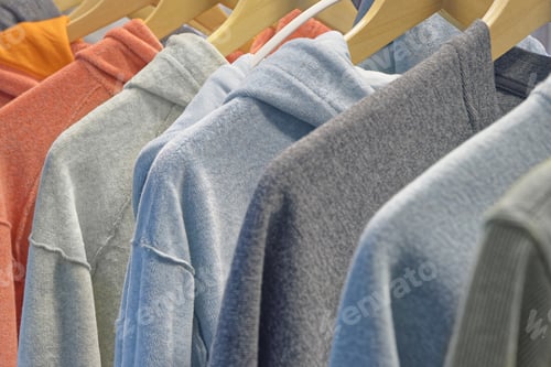 Preview: Personal wardrobe or shop window, group of hoodies and sweatshirts of different colors on hangers