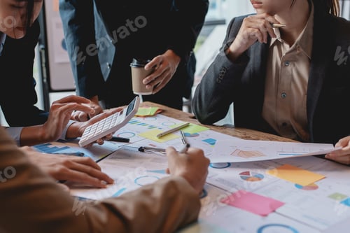 Preview: Groups of businesspeople working together as a team of analytics point to company graphs and chart