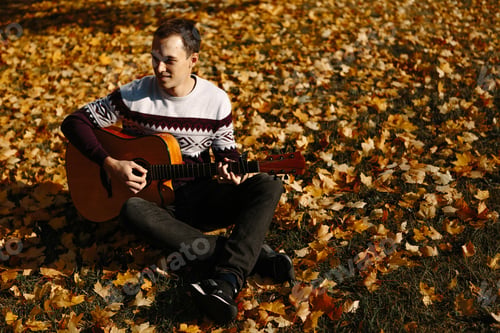 Preview: Handsome Guy With Guitar In The Autumn Park