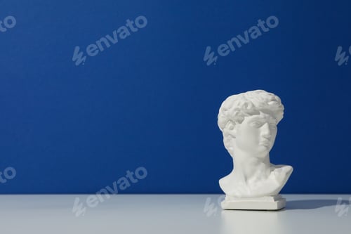 Preview: Ancient head on blue background, space for text