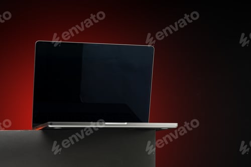 Preview: Laptop with black screen against dark red background