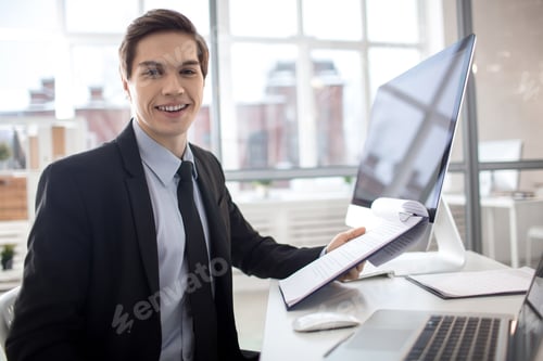 Smiling Man in Suit with Documents in Office