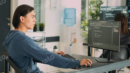Preview: Asian programer developing database interface and writing server code