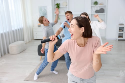 Preview: Young woman singing karaoke with friends at home, selective focus