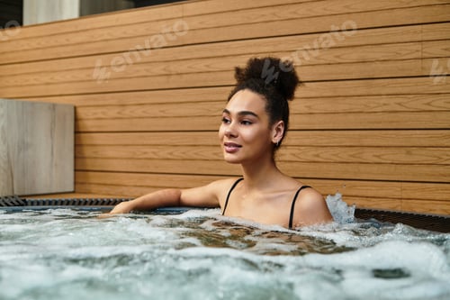Preview: Relaxing moments in a soothing spa for a young African American woman enjoying wellness