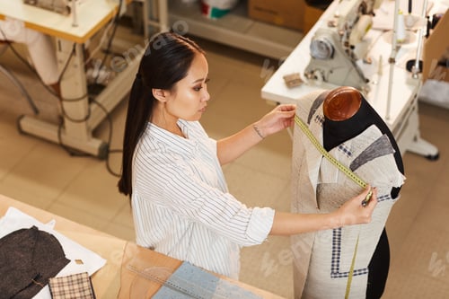 Preview: Woman sewing suit in atelier
