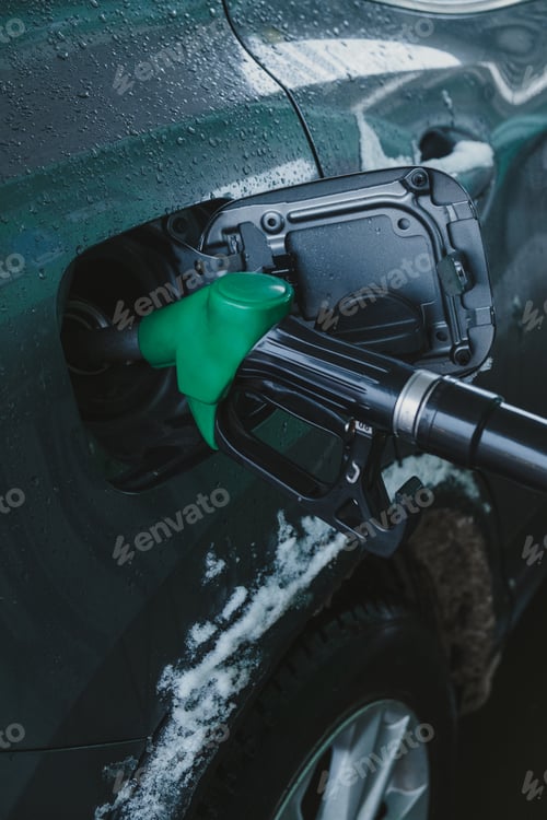 Preview: A gas pump nozzle in a car's fuel tank.