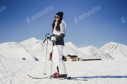 Preview: Young Woman Skiing In Snowy Mountain Scenery