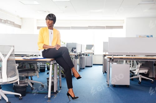 Preview: Businesswoman sitting on the table in office