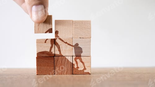Preview: Wooden puzzle of climbers helping each other to reach the summit- concept of teamwork