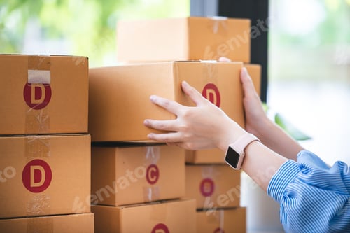 Preview: Small start-up business owners checking parcels at work, freelancers, salespeople, checking producti