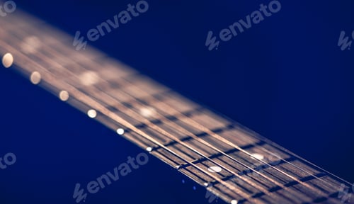 Preview: Part of an acoustic guitar, guitar fretboard on a black background.