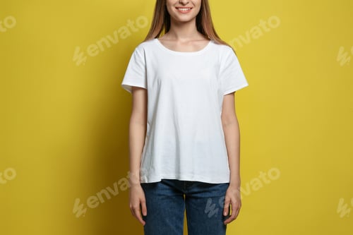 Preview: Young woman wearing blank t-shirt on yellow background, closeup. Mockup for design