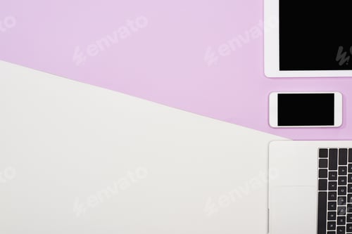 Preview: flat lay with laptop, digital tablet with blank screen and smartphone on violet and white background